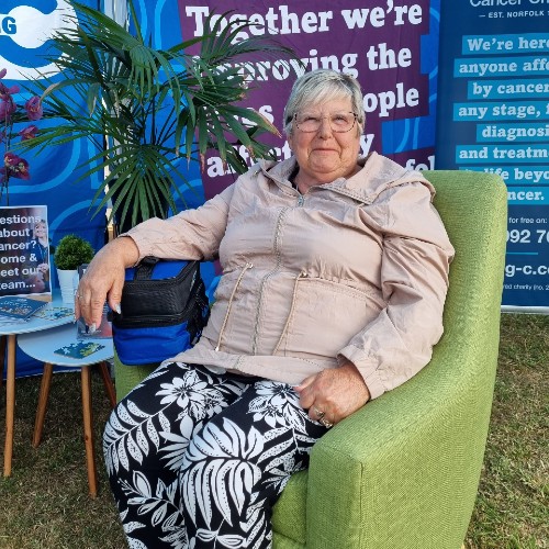 Volunteer Janice, sitting in a green comfy chair at the Royal Norfolk Show