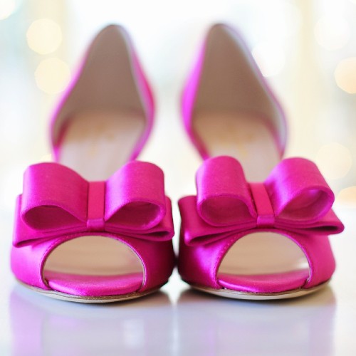 Pink shoes with a bowtie on the front