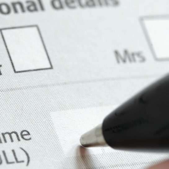 Close up of someone filling in a paper form