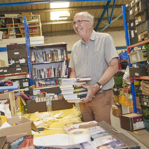 A picture of a Big C employee smiling, in the sorting department in the Distribution centre.