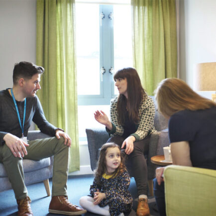 A small family receiving family therapy at a support centre.