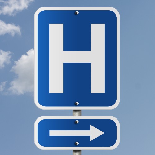 A road sign with the letter H on, directing people to the nearest hospital.