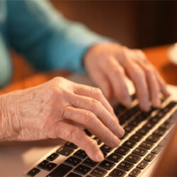 A close up of a person typing on a laptop