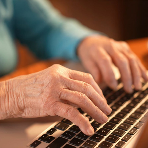 A close up of a person typing on a laptop