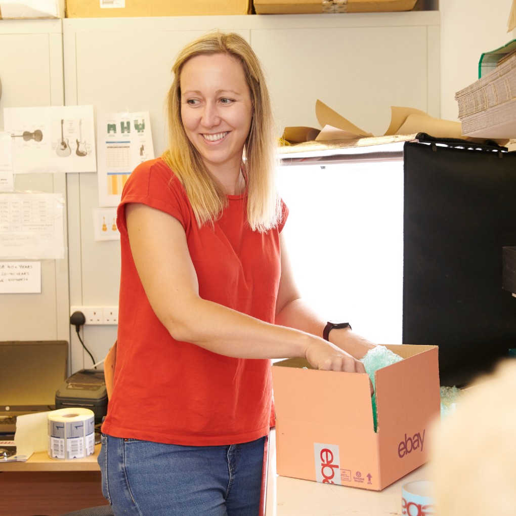 A Big C volunteer packing a box in one of our shops.