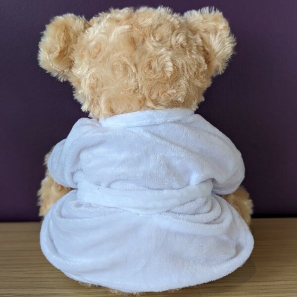 The back view of Charlie Bear, Big C's teddy bear, wearing a white dressing gown