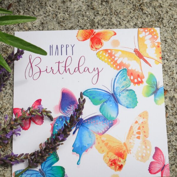 A greetings card with painted multi-coloured butterflies