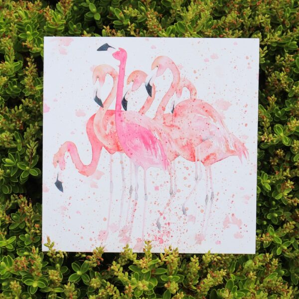 A greetings card covered in painted pink flamingos