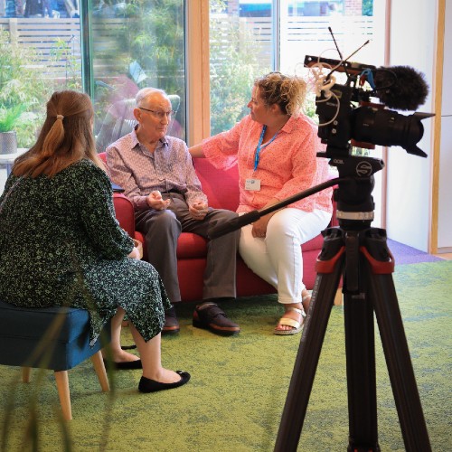 Service user Russell talking to the support team at the Norwich City Support Centre, following some filming.