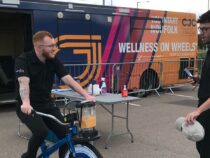 Two men outside the WOW Bus (Wellness on Wheels)