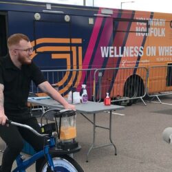 Two men outside the WOW Bus (Wellness on Wheels)