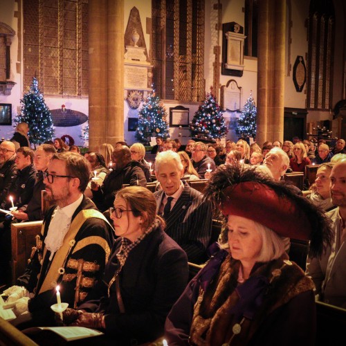 People sitting in church for the Remember in December service