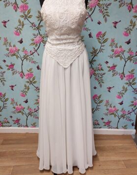 Victoria Jane ivory dress, with a high neckline and flower detailing